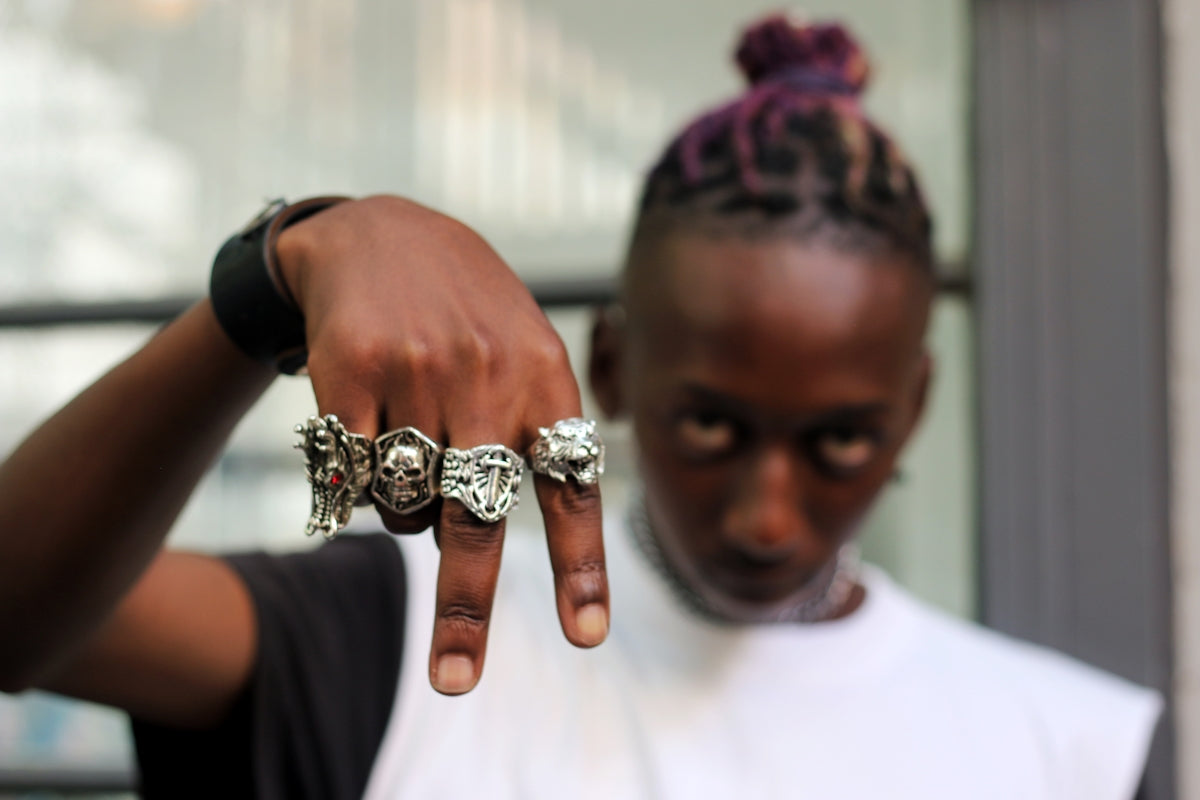 man in white crew neck shirt wearing silver diamond ring
