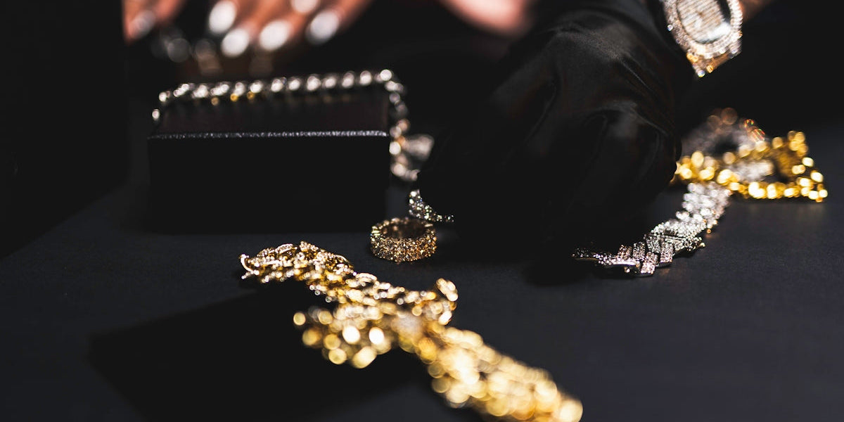 a close up of a person's hands with gold jewelry