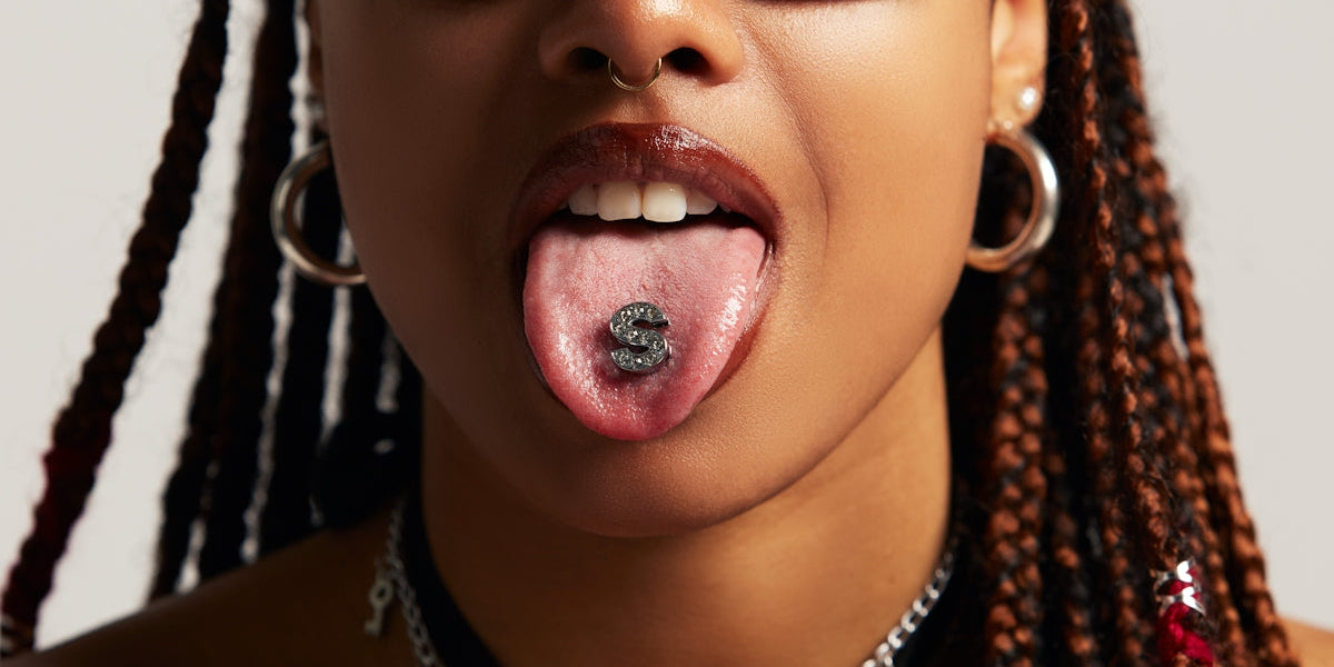 a woman sticking her tongue out with sunglasses on