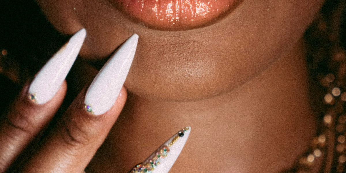 a close up of a person with white nails