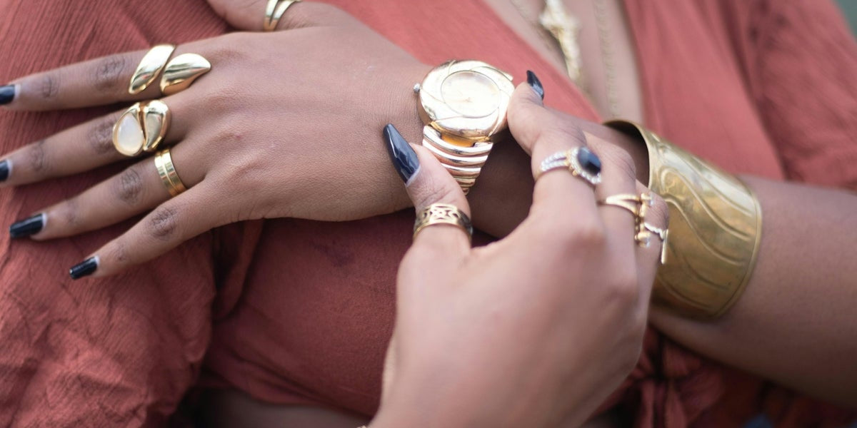 Woman with jewelry checks her wristwatch.