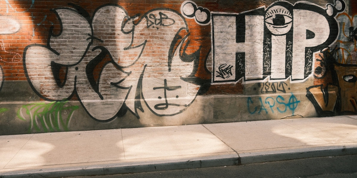 Graffiti art adorns a brick wall.