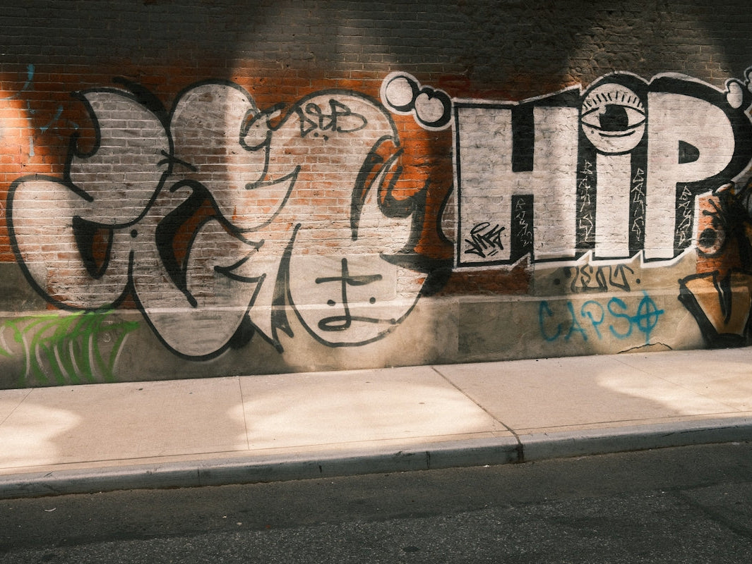 Graffiti art adorns a brick wall.
