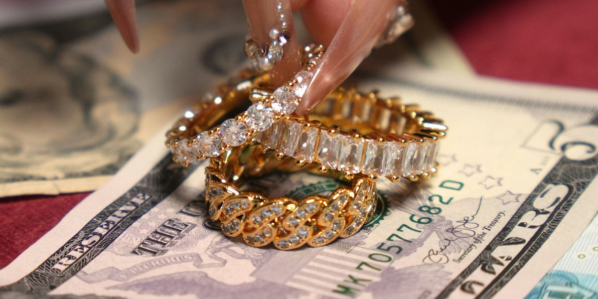 Diamond rings resting on us dollar bills