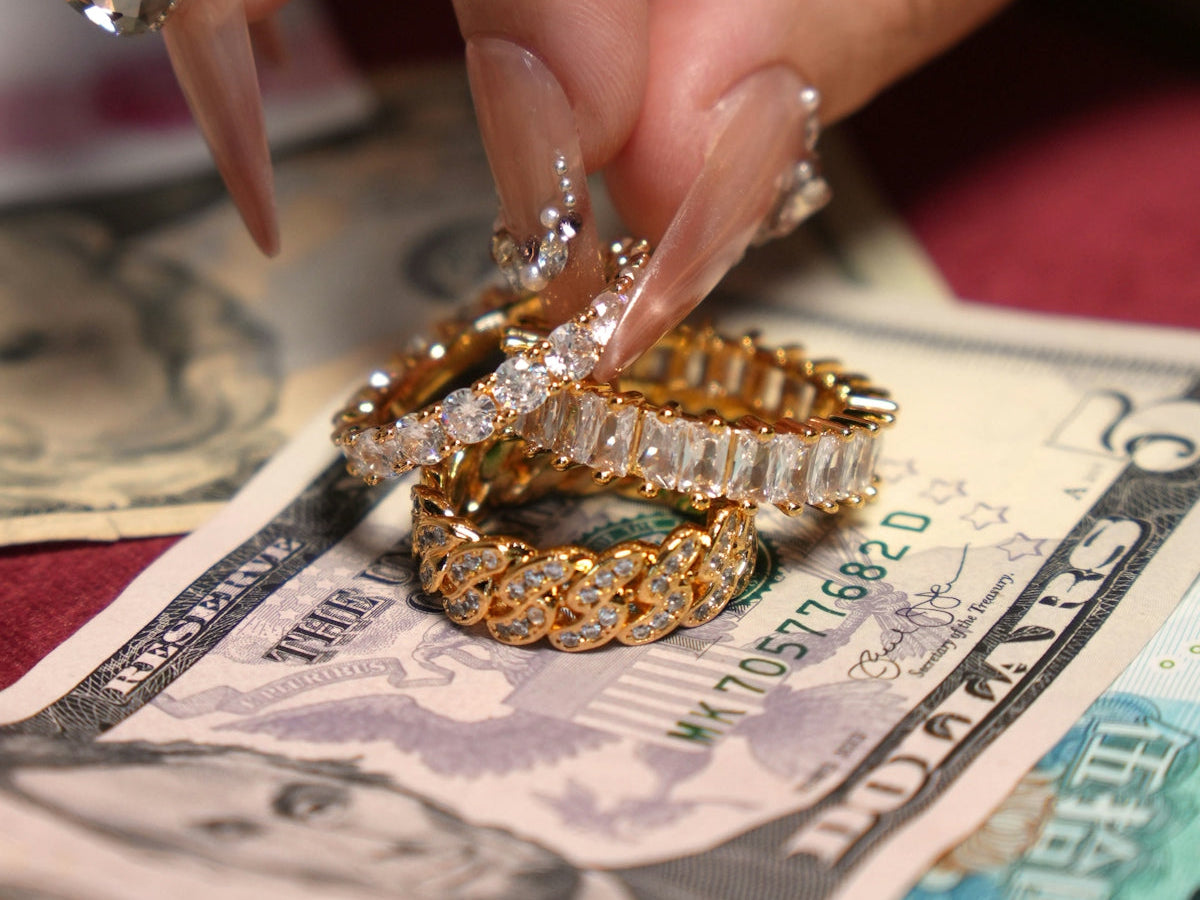 Diamond rings resting on us dollar bills