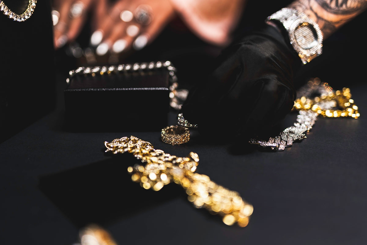 a close up of a person's hands with gold jewelry