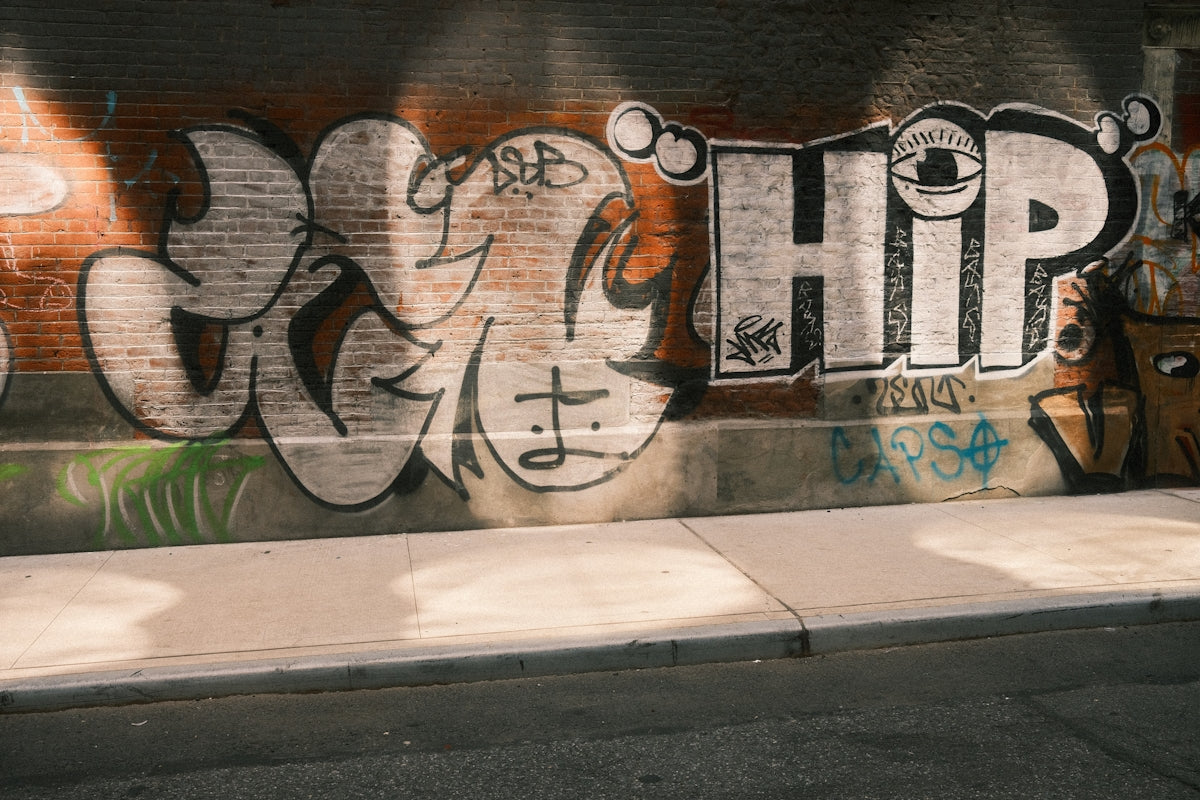 Graffiti art adorns a brick wall.