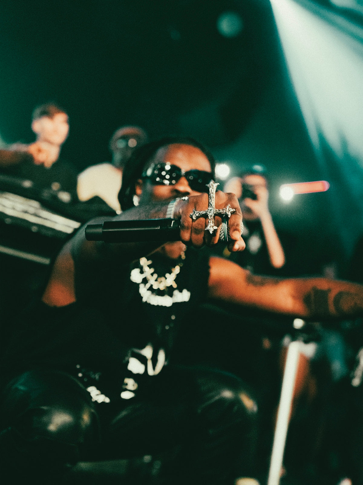 Rapper performing on stage with a microphone.