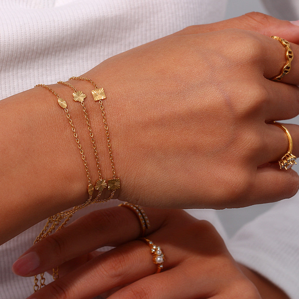 Ladies 18k Gold Over Stainless Steel Waterproof Sunburst Oval Flower Charm Bracelet